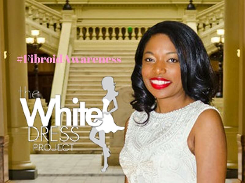 Woman in a white dress smiling, supporting the White Dress Project and #fibroid awareness.