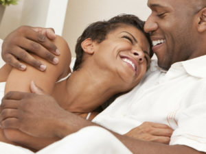 A happy couple holding each other, happy about uterine fibroid treatment. 