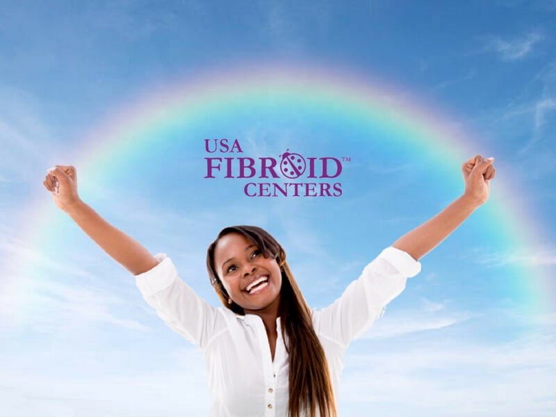 Uterine Fibroids | What Every Woman Needs To Know 3 Young Woman smiling, arms outstretched to the sky--a rainbow & the USA Fibroid Centers' logo above.
