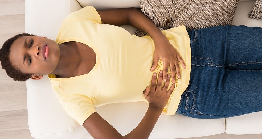 Woman experiencing abdominal pain from Uterine Fibroids