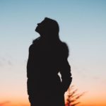silhouette of a woman staring at the sky