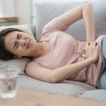 Woman experiencing severe cramps from an irregular period