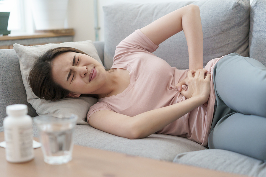 Woman experiencing severe cramps from an irregular period