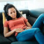 Woman struggling with fibroids. Do fibroids go away on their own?