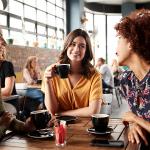 3 women at a table discussing uterine fibroids and their health