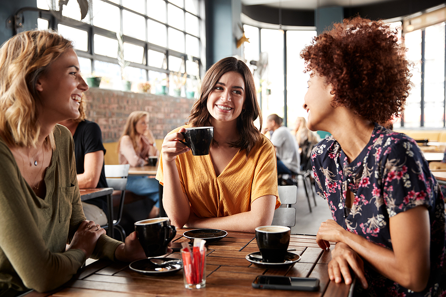 3 women at a table discussing uterine fibroids and their health