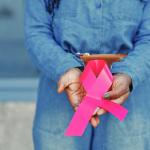 Woman holding Breast Cancer Awareness ribbon
