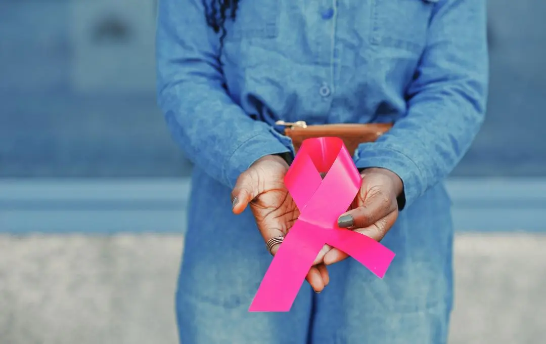 What Women With Fibroids Need To Know About Breast Cancer 1 Woman holding Breast Cancer Awareness ribbon