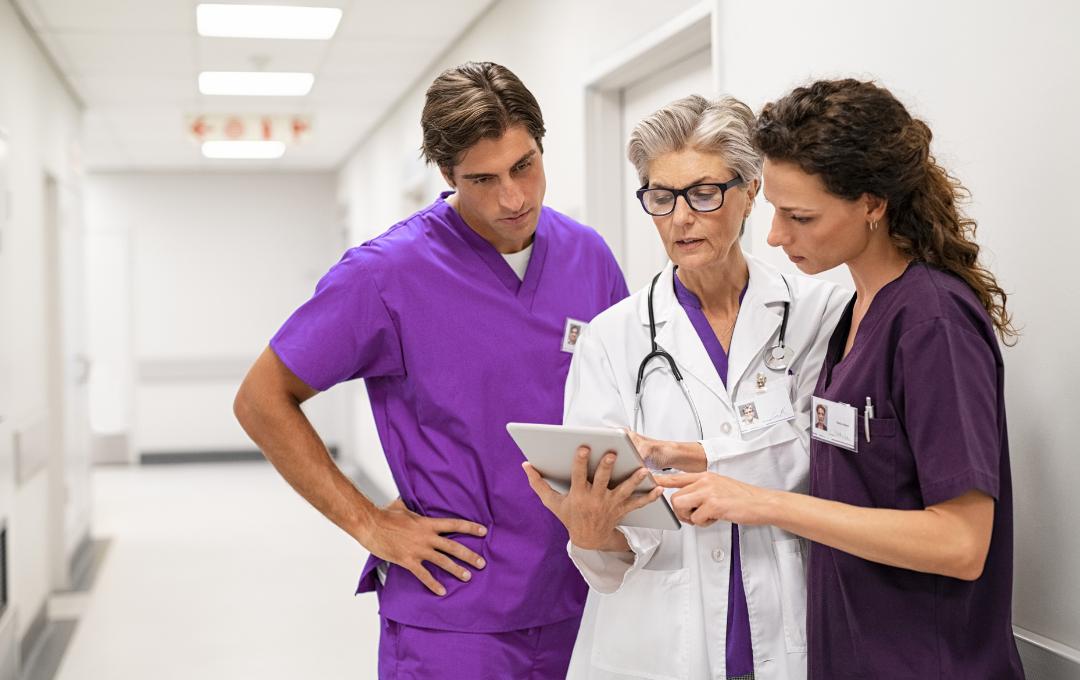 Why Do Fibroids Cause Heavy Bleeding And Clots During A Period? 6 A group of fibroid specialists reviewing and discussing the diagnostic results of a patient.