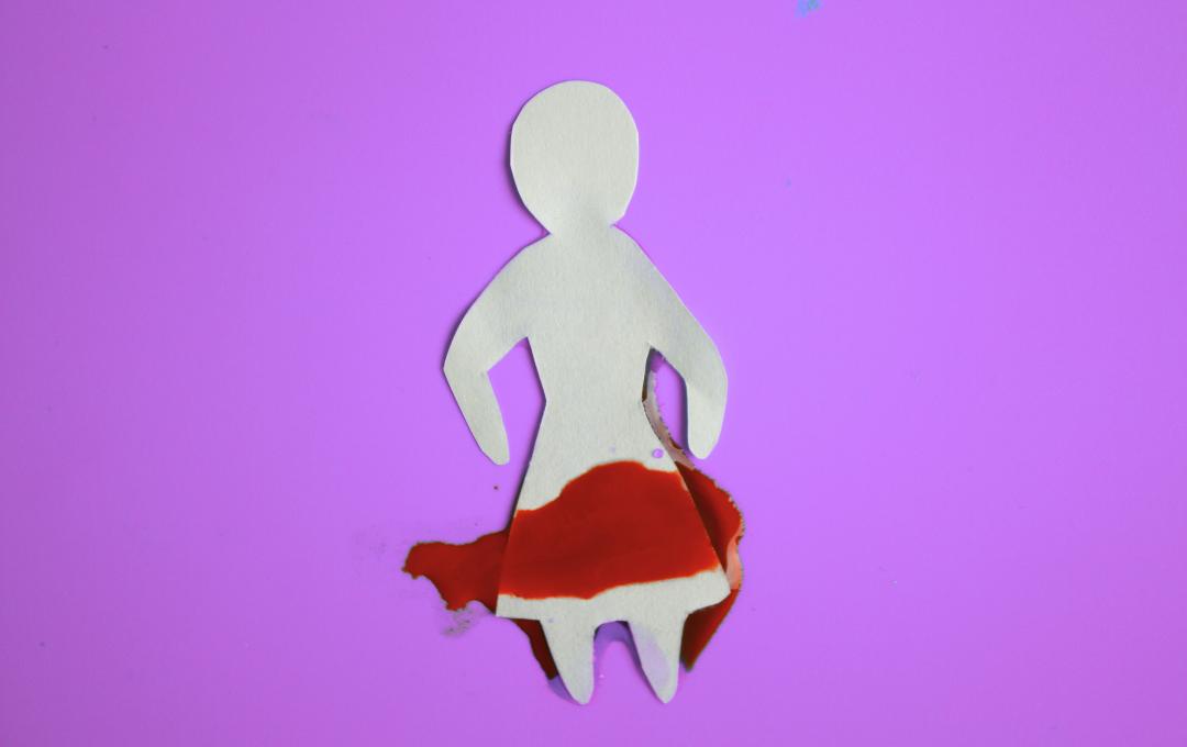 Why Do Fibroids Cause Heavy Bleeding And Clots During A Period? 2 A paper cut out of a woman experiencing heavy bleeding