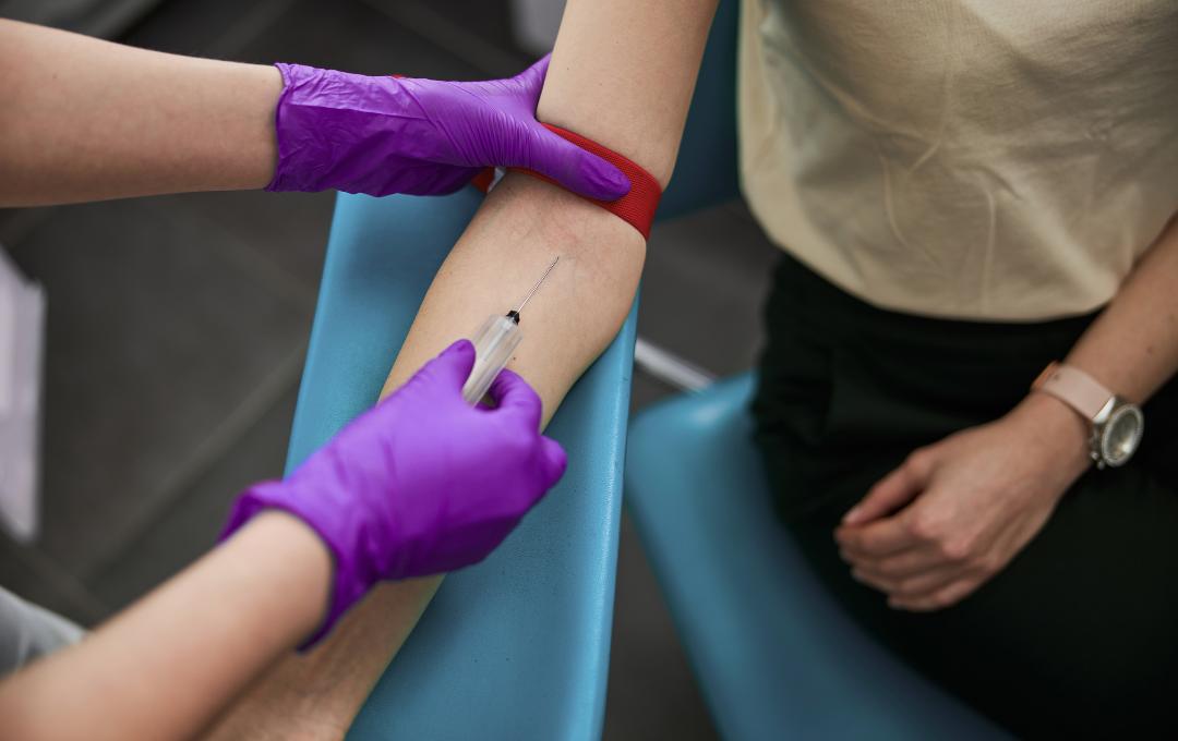 Common Questions About The Detection Of Fibroids 4 Phlebotomist drawing blood for blood work test.