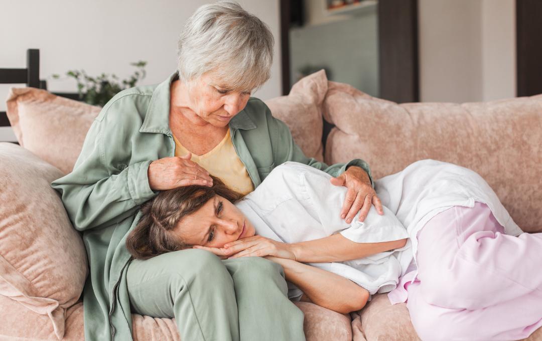 Can Fibroids Cause Miscarriages? 5 Woman with fibroids concerned risk of miscarriage being comforted by her mother or grandmother