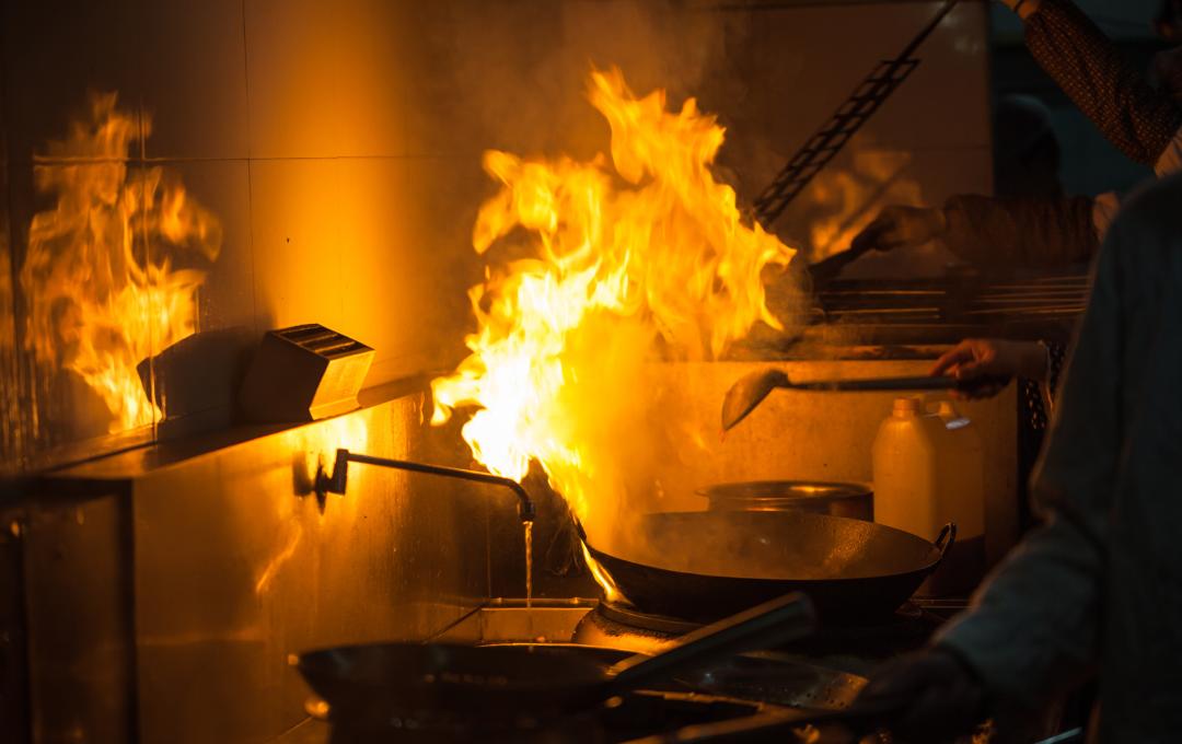 Do Fibroids Cause Pain During Ovulation? 2 Fire breaking out in a wok in the kitchen.
