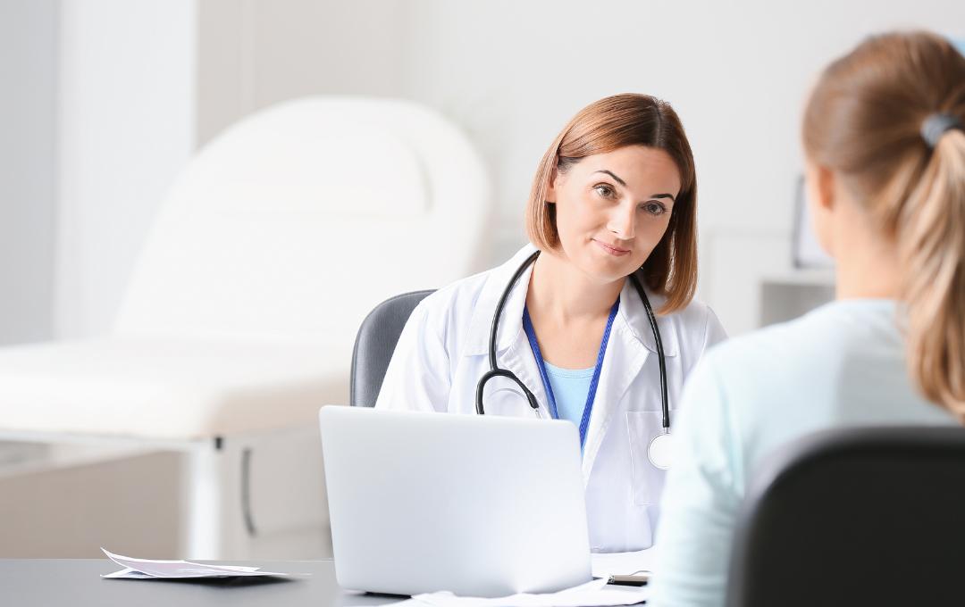 What Does Brown Vaginal Discharge Mean? 4 A fibroid specialist with a woman.
