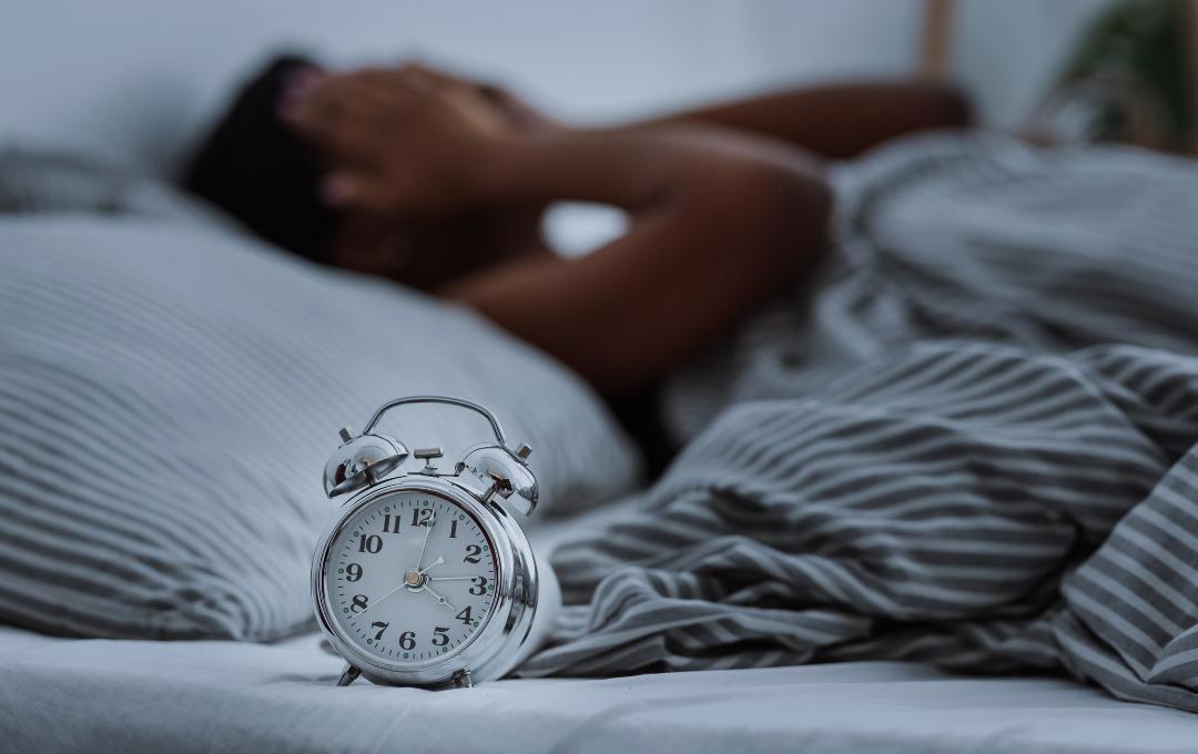 Can Fibroids Cause Headaches? 2 Woman in bed struggling to fall asleep.